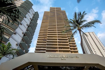 A modern living room with a dining area, a sofa set, and a coffee table. at Aston Waikiki Beach Tower