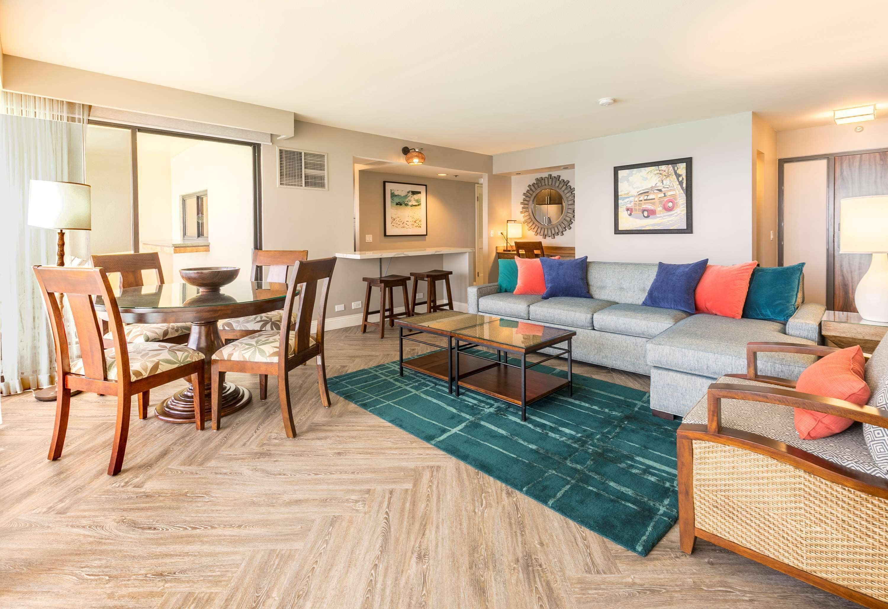 A modern living room with a dining area, a sofa set, and a coffee table.
