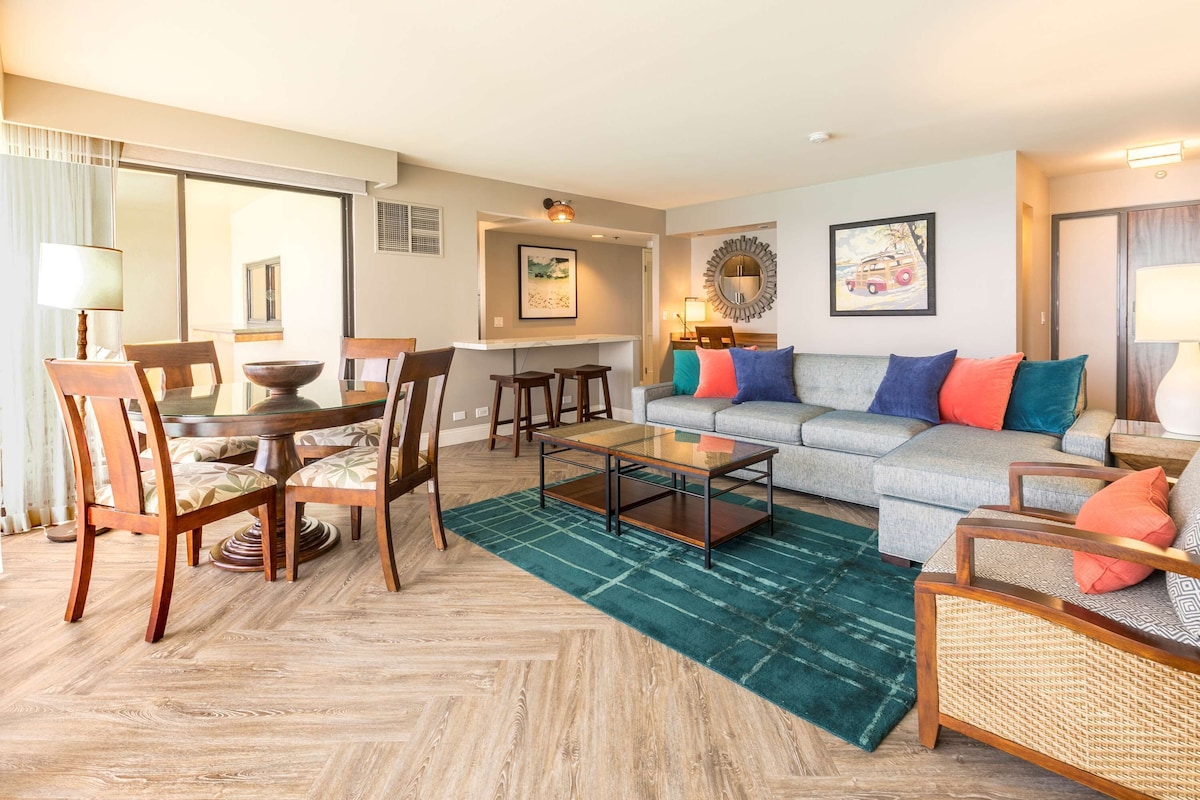 A modern living room with a dining area, a sofa set, and a coffee table.