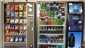 Three vending machines with snacks and drinks.