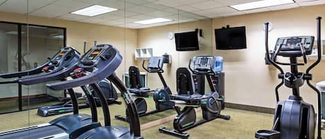 A fitness center with treadmills, elliptical machines, and weight machines.