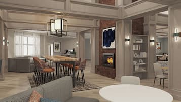 A spacious living area with a dining table, sofas, and a fireplace.