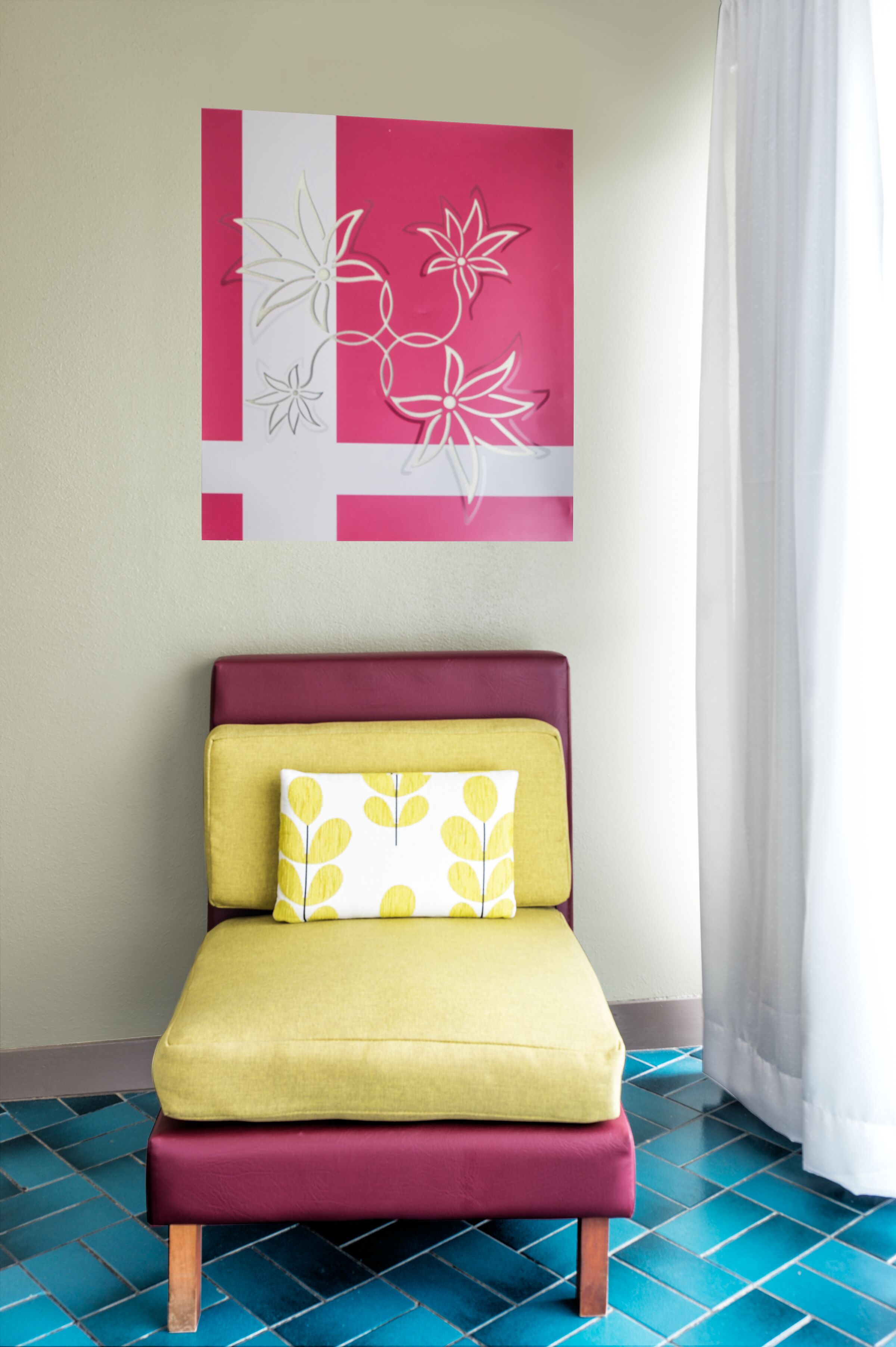 A small bed with a yellow and maroon headboard, a white pillow with a yellow leaf pattern, and a pink and white abstract wall art piece above it.