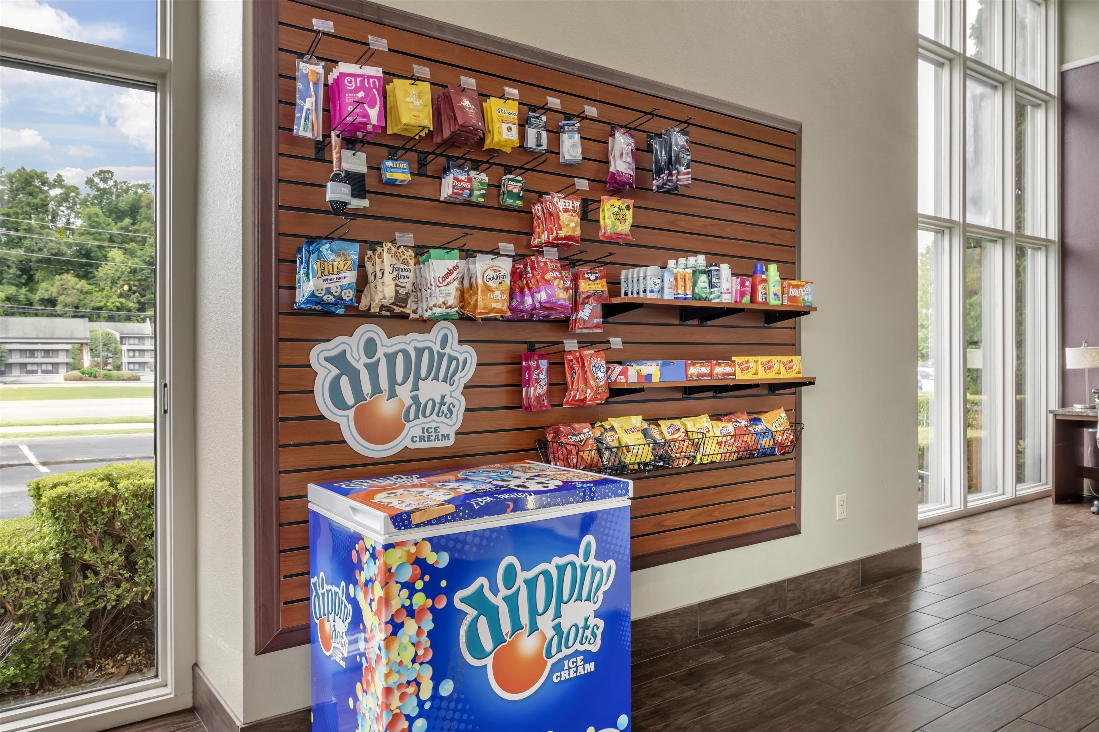 A retail display with various snacks and beverages, including a prominent ice cream freezer.