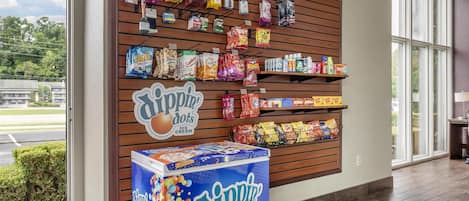 A retail display with various snacks and beverages, including a prominent ice cream freezer.