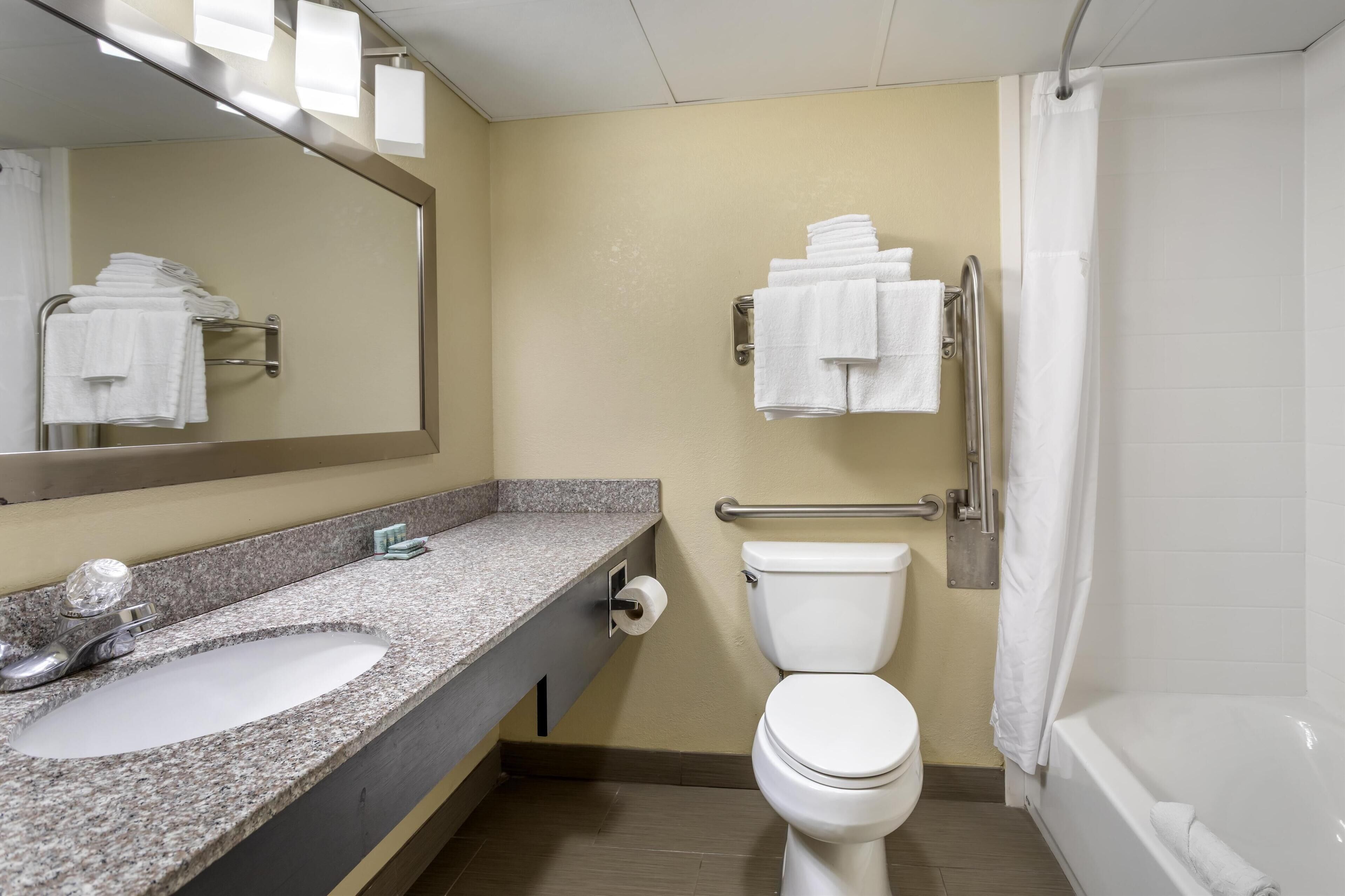 A bathroom with a sink, toilet, and bathtub.