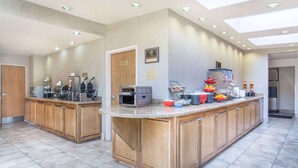 A modern kitchen with a central island, built-in appliances, and a breakfast bar.
