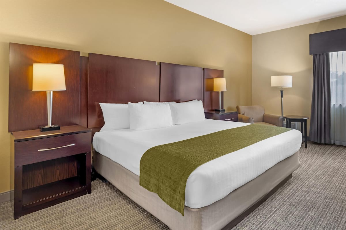 Premium bedding, desk, laptop workspace, iron/ironing board