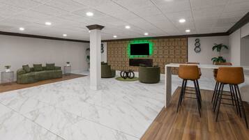 A modern interior with a seating area, a dining space, and a flat-screen TV mounted on a patterned wall.