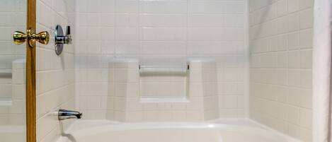 A bathroom with a bathtub, a shower, and a toilet.