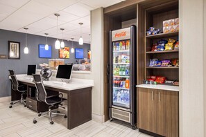 A modern office space with desks, chairs, a refrigerator stocked with beverages, and snack shelves. - Comfort Inn Greenville - Haywood Mall (Greenville)