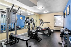 A gym with cardio machines, dumbbells, and a bench. - Comfort Inn Greenville - Haywood Mall (Greenville)
