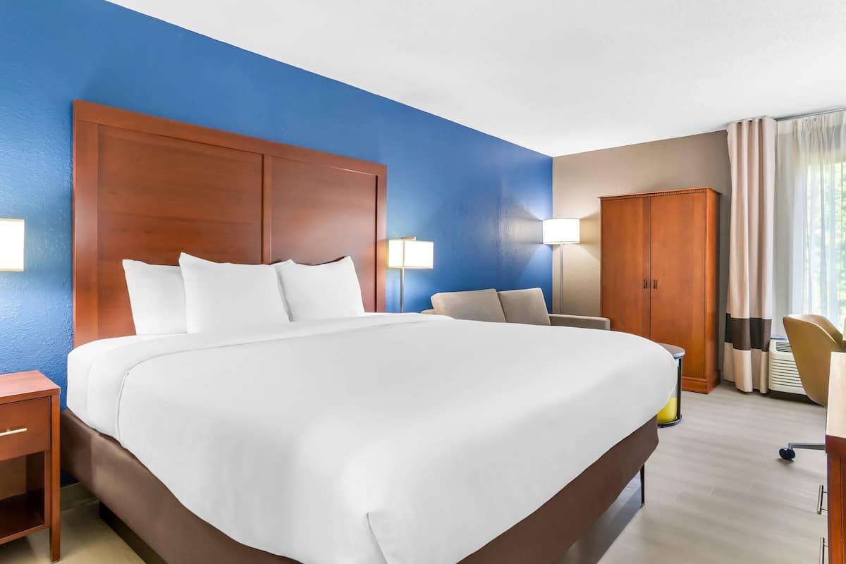 Premium bedding, desk, laptop workspace, blackout curtains
