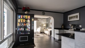 A modern kitchen with a built-in coffee station, a vending machine, and a view to the outside.