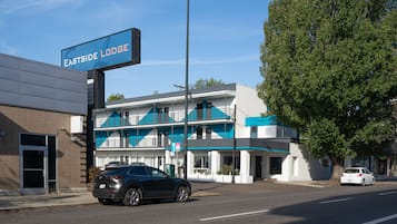 A building with a sign reading "Eastside Lodge" and a modern architectural style with a blue and white color scheme.