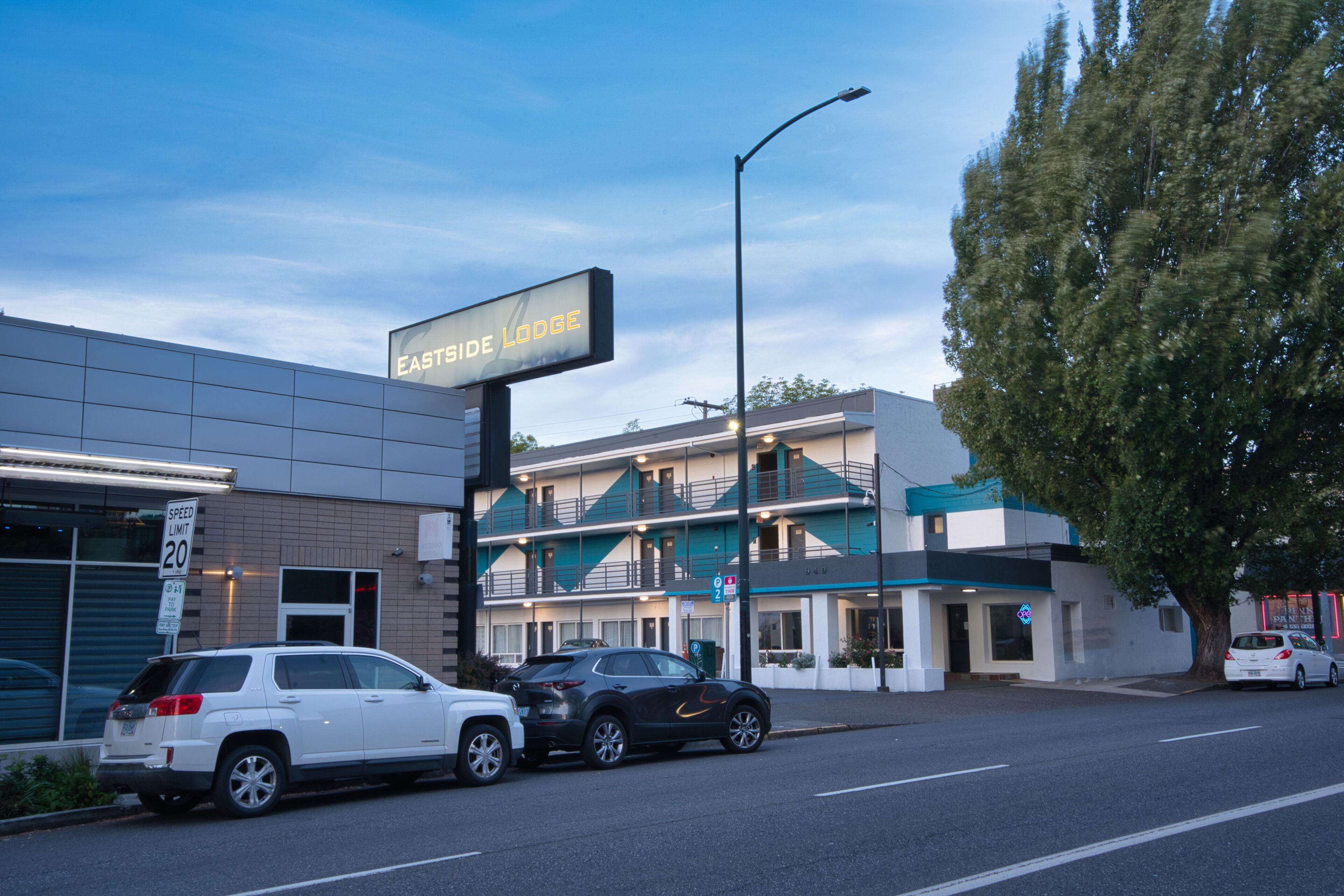 A building with a sign reading "Eastside Lodge" and a speed limit sign of 20.
