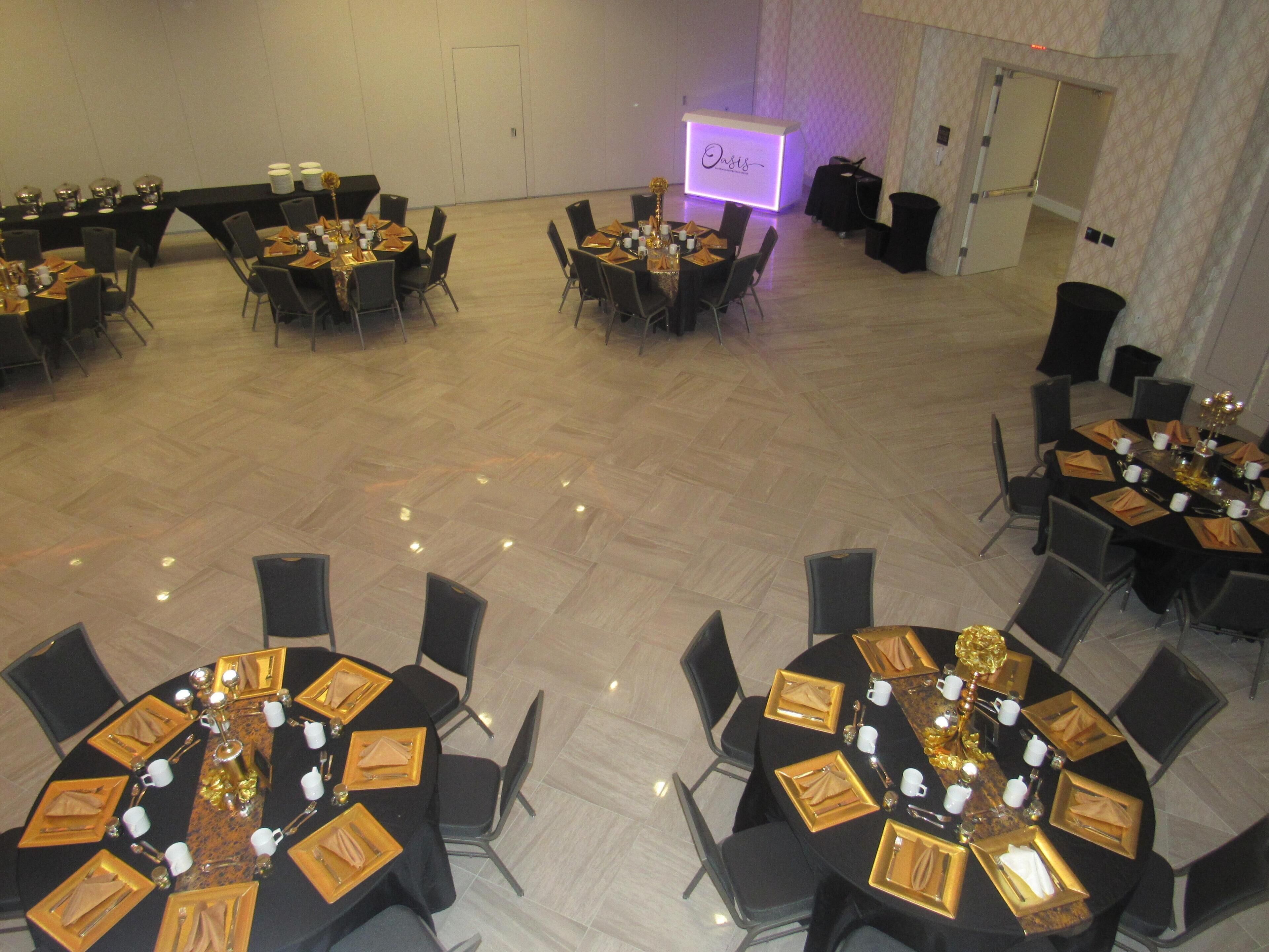 A conference room with multiple tables set for a meeting, equipped with nameplates, chairs, and table settings.