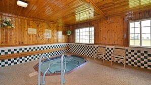 A wooden interior with a checkered floor, a pool, and benches. - Quality Inn & Suites Grinnell near University (Grinnell)