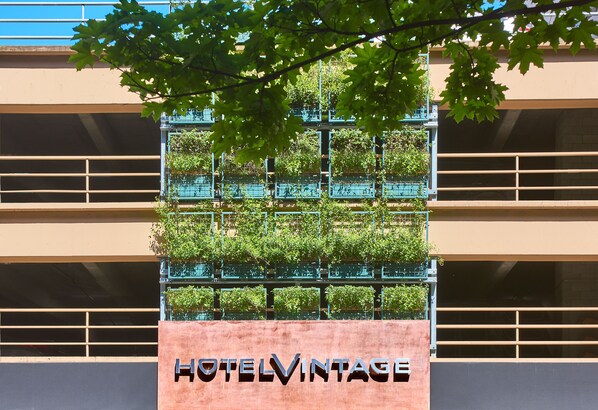 A building with a sign reading "HOTELVINTAGE" and a balcony with greenery. - Kimpton Hotel Vintage Seattle by IHG (Seattle)