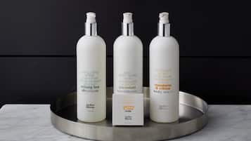 Three bottles of body wash on a metallic tray.