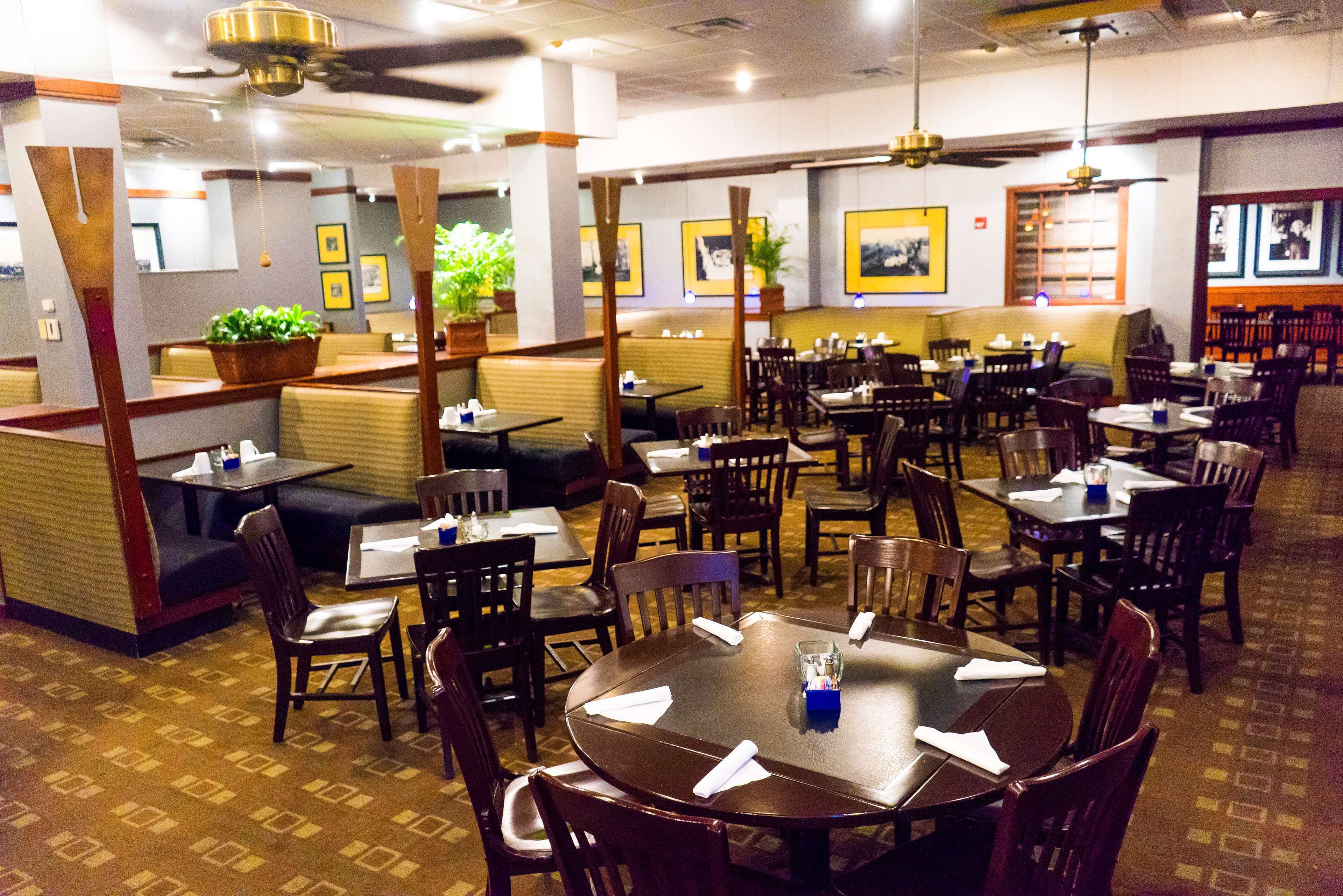 A restaurant with booths, tables, and chairs.