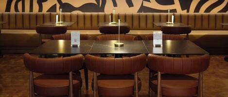 A restaurant with booths and tables, each with a menu stand.