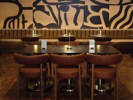 A restaurant with booths and tables, each with a menu stand.