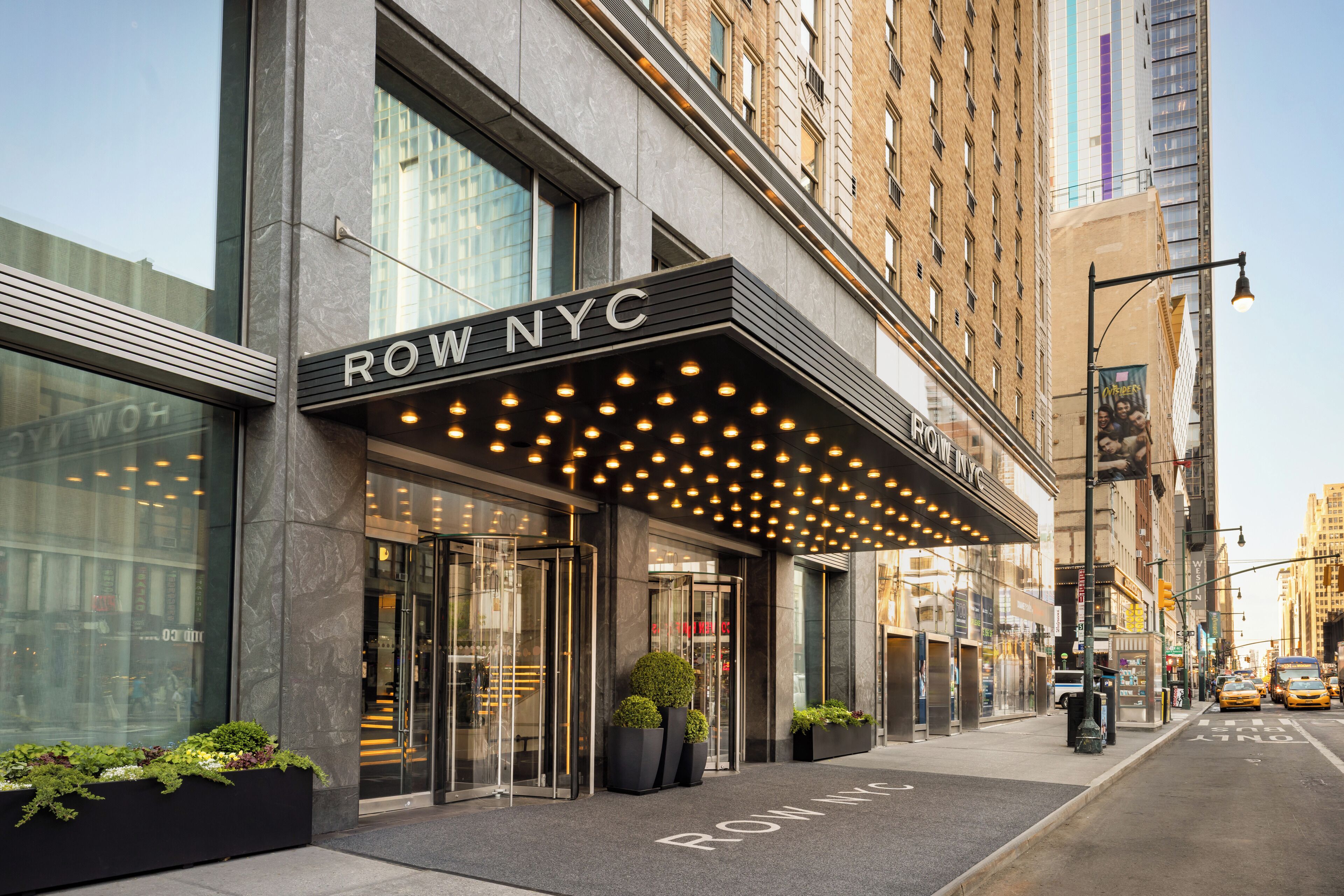 A building with a marquee sign reading 'ROW NYC' and a glass entrance.