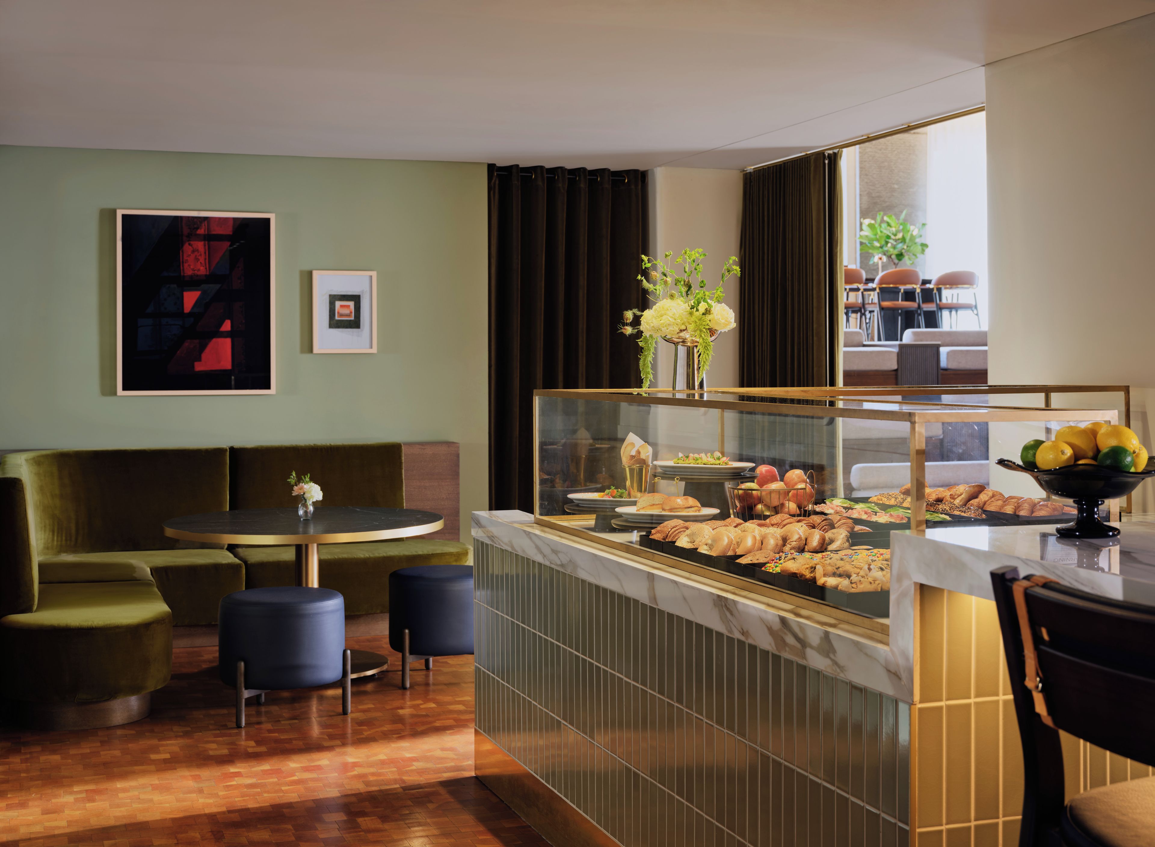 Une chambre d’hôtel avec un coin salon, un buffet proposant divers plats et une vue sur l’extérieur.