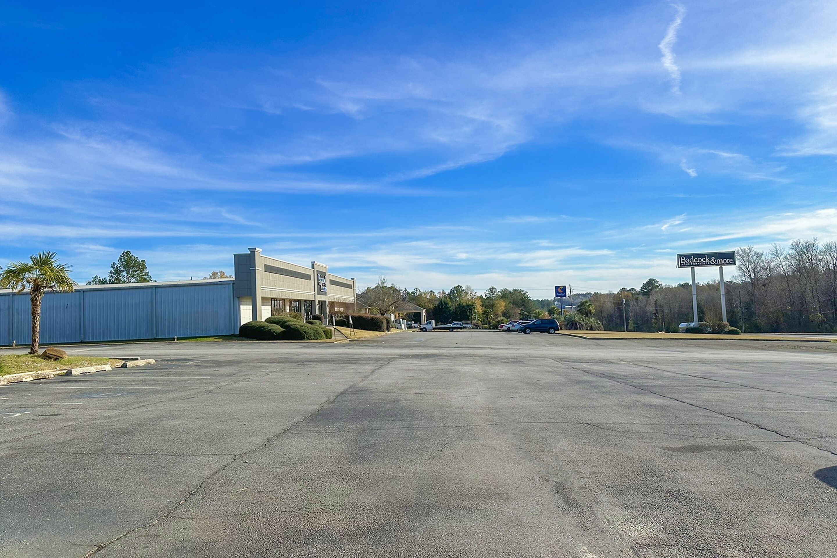 A parking lot with a building labeled "Backcock & More" in the background.