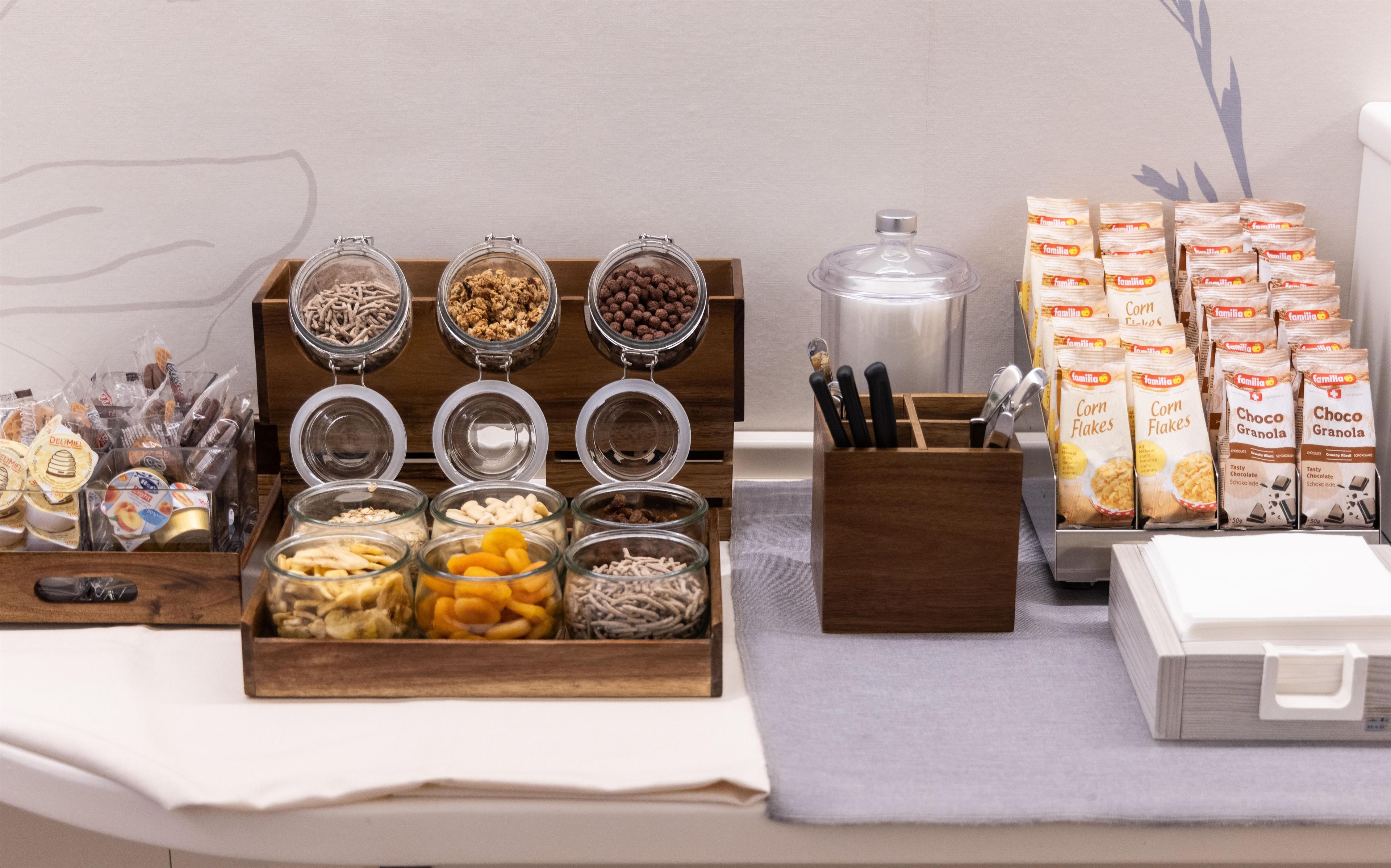 A buffet setup with various food items and condiments.