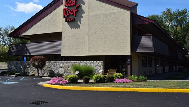 Un hôtel Red Roof Inn avec une façade en pierre, une entrée bien visible et un parking avec des places réservées aux personnes handicapées.