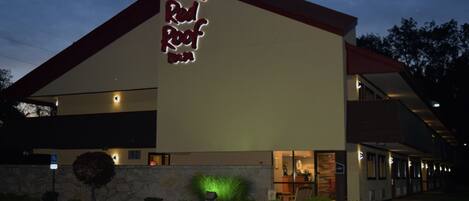 A building with a prominent sign reading 'Red Roof Inn.'