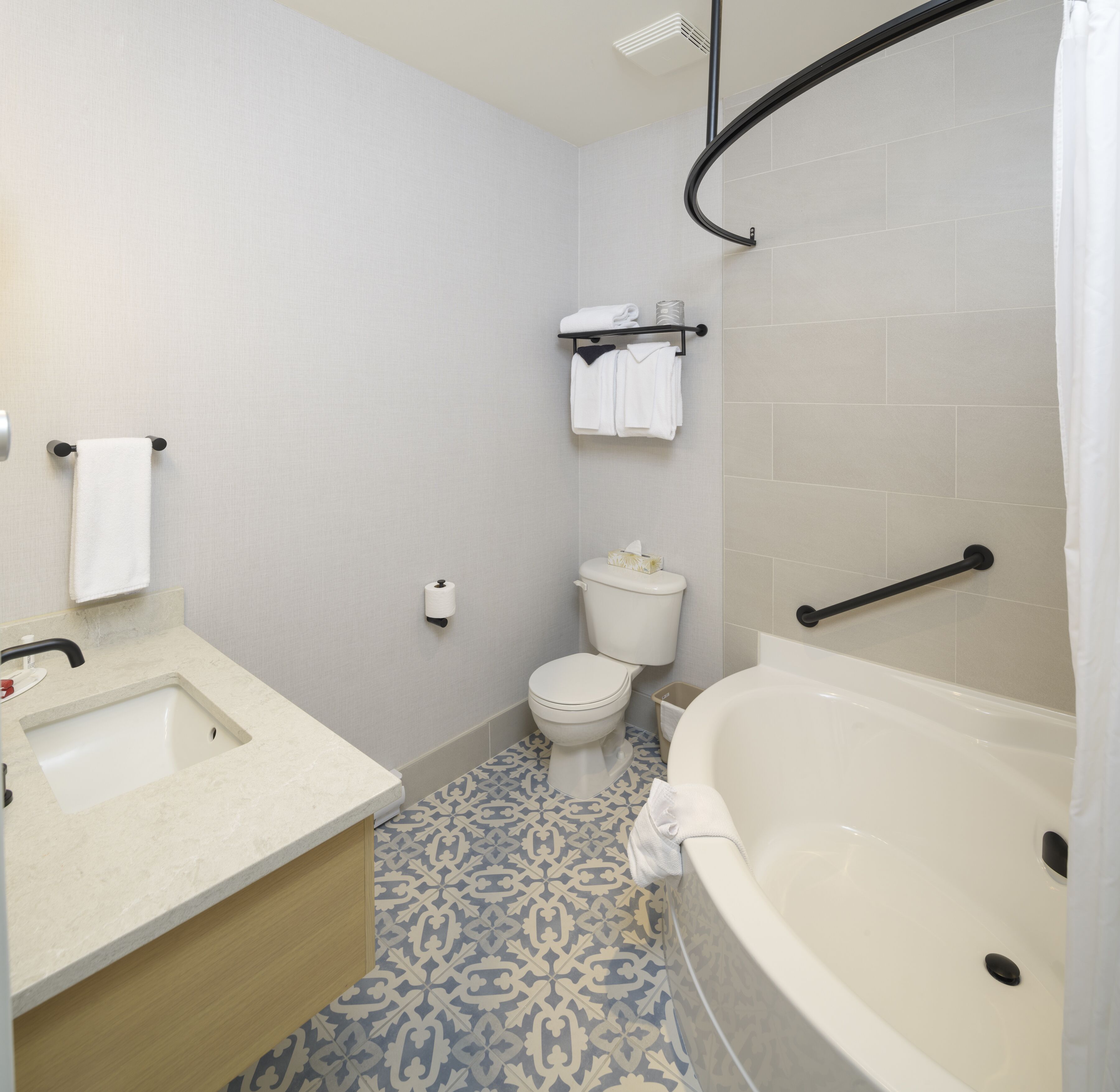 A bathroom with a sink, toilet, and bathtub.