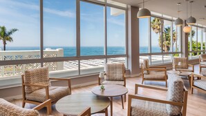 A spacious lounge area with large windows offering a view of the beach and ocean. - Sol Marbella Estepona - Atalaya Park (Estepona)