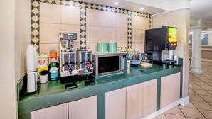 A hotel reception area with a coffee machine, a microwave, and a beverage dispenser. - La Quinta Inn by Wyndham Lufkin (Lufkin)