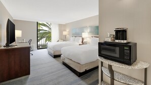 A hotel room with two beds, a TV, a microwave, and a coffee maker. - Hilton Irvine/Orange County Airport (Irvine)