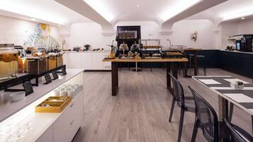 Un ricco buffet della colazione con diversi cibi e un angolo caffè.
