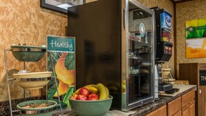 A kitchen area with a fruit bowl, a coffee machine, and a sign labeled "Healthy". - Quality Inn Hermitage South (Hermitage)