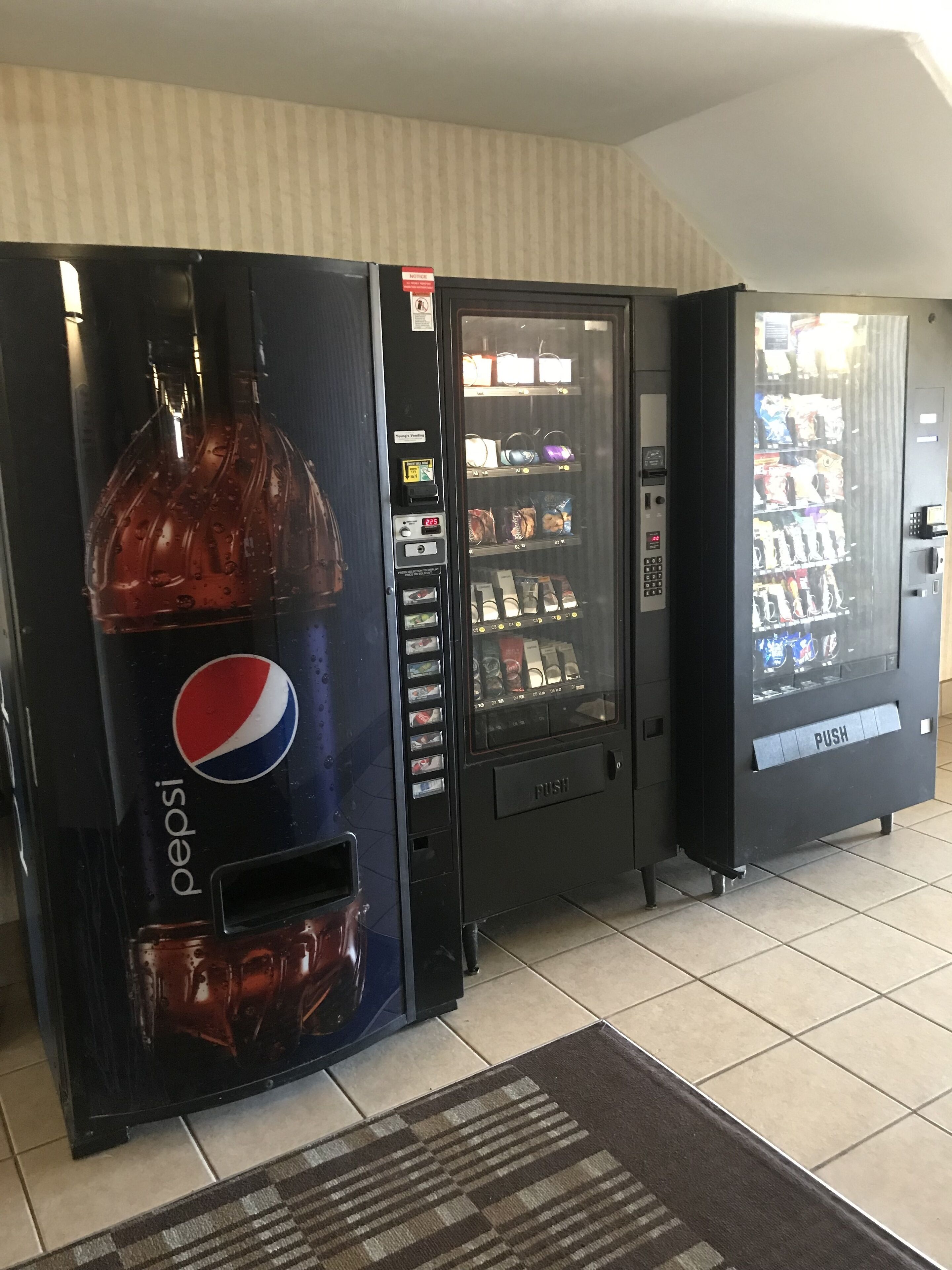 A vending machine with a Pepsi logo, a drink dispenser, and a payment interface.