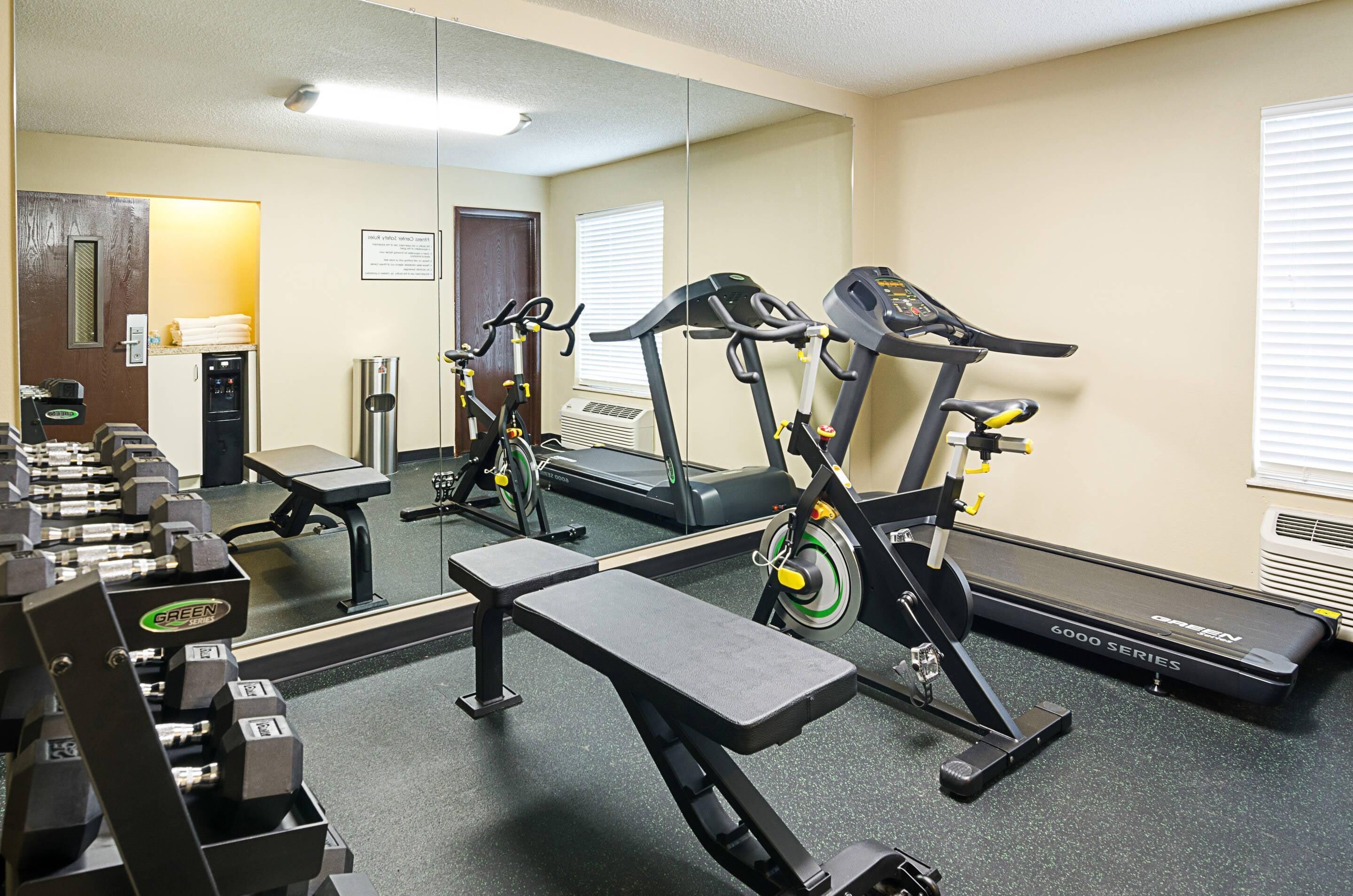 A gym with treadmills, stationary bikes, and weight machines.
