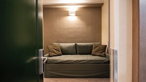 A compact room with a bed, a door, and a light fixture on the ceiling. - Best Quality Hotel Gran Mogol (Turin)