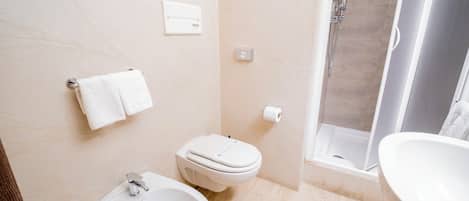 A modern bathroom with a sink, toilet, and shower.