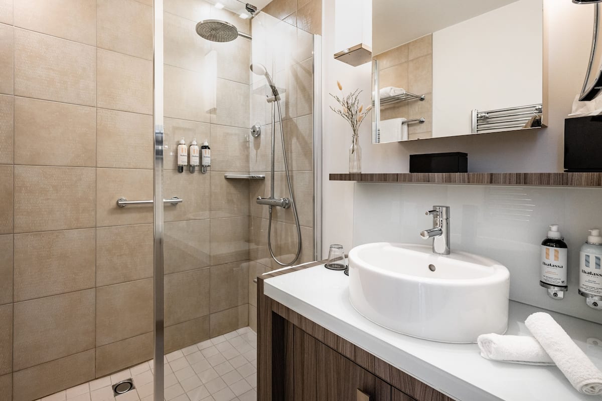 rainfall showerhead, designer toiletries, hair dryer, bathrobes