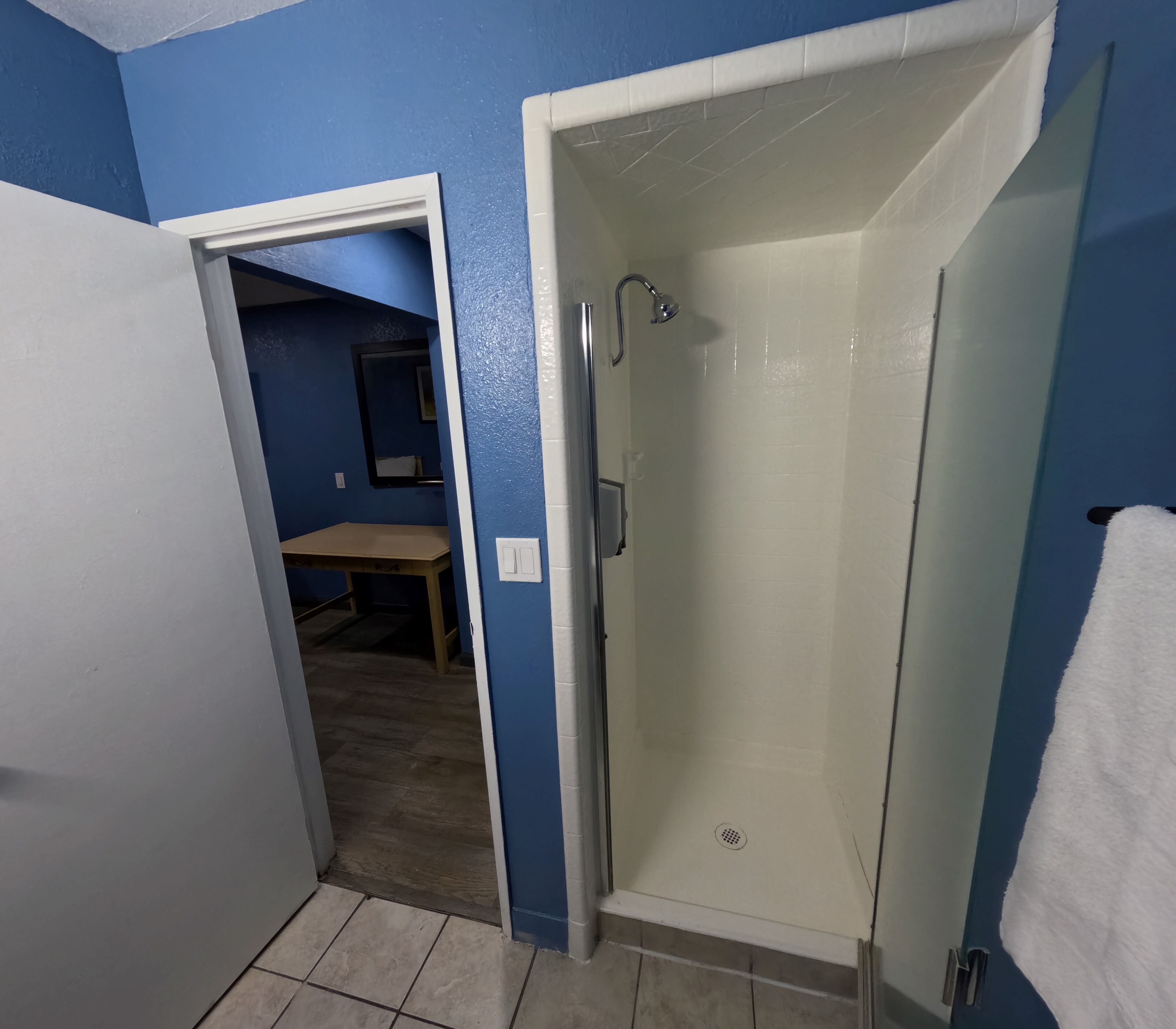 A bathroom with a shower, a toilet, and a sink.