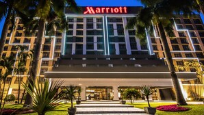 A Marriott hotel with a modern facade, multiple floors, and a well-lit entrance.