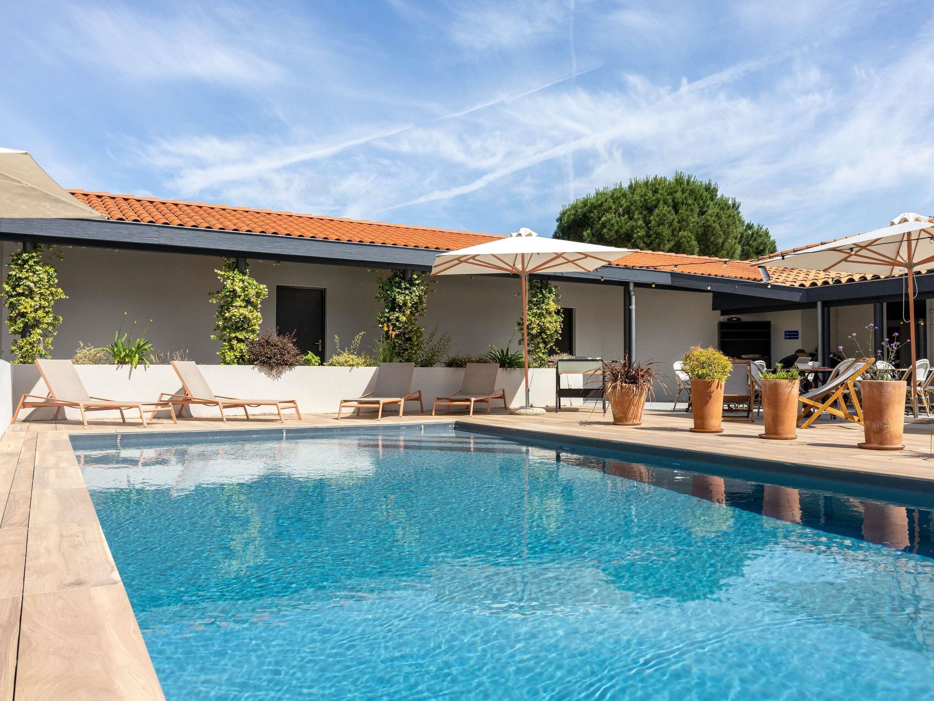 Seasonal outdoor pool, open 10:00 AM to 10:00 PM, pool umbrellas