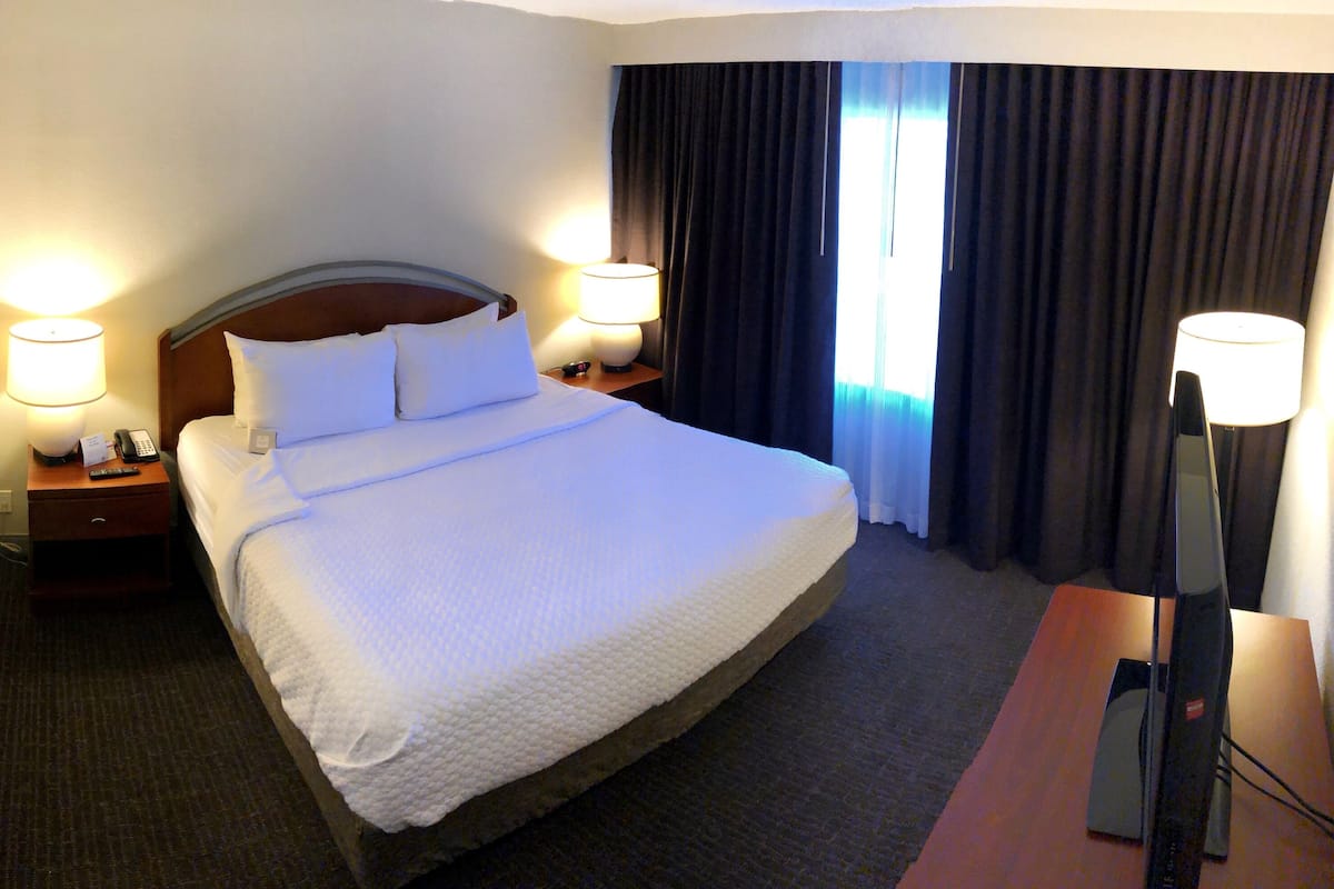 Premium bedding, desk, laptop workspace, iron/ironing board