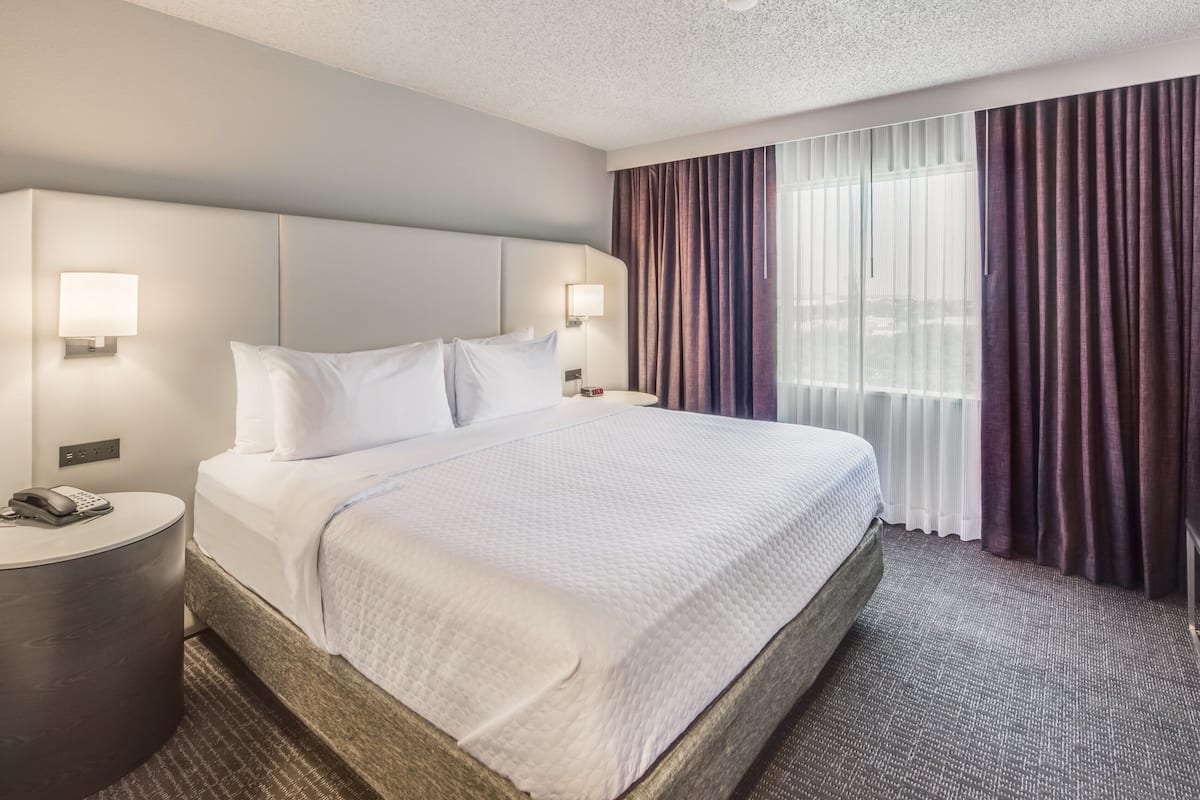 Premium bedding, desk, laptop workspace, iron/ironing board