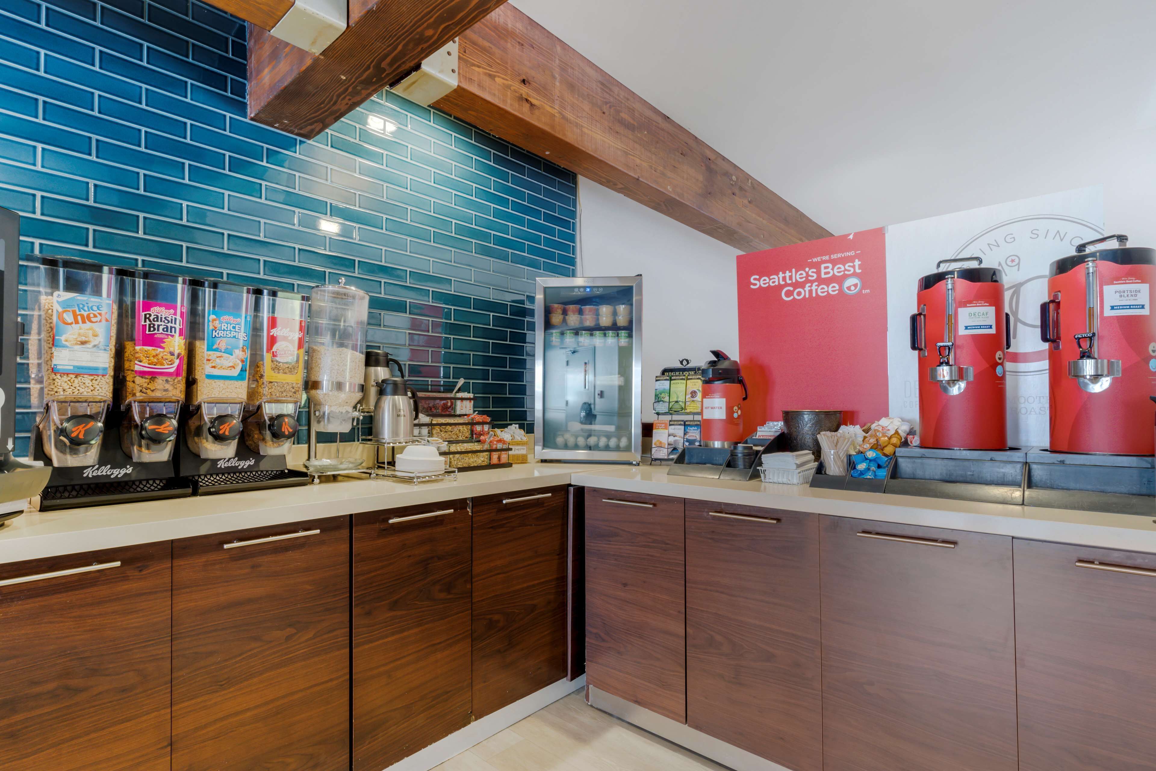 A kitchen with a coffee station, including a coffee machine and containers of coffee beans.